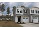 Charming two-story townhome with stone accents and an attached one car garage at 141 Rolesville Ridge Drive Dr, Rolesville, NC 27571