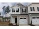 Charming two-story townhome with stone accents and an attached one car garage at 141 Rolesville Ridge Drive Dr, Rolesville, NC 27571