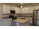 Modern kitchen features white cabinets, stainless appliances, granite countertops, and island with sink at 141 Rolesville Ridge Drive Dr, Rolesville, NC 27571