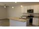 Bright kitchen features white cabinets, stainless appliances, granite countertops, and island with sink at 141 Rolesville Ridge Drive Dr, Rolesville, NC 27571