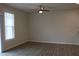 Bright living room with vinyl floor, ceiling fan, and sliding glass door to the backyard at 141 Rolesville Ridge Drive Dr, Rolesville, NC 27571