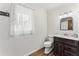 Charming bathroom with wood-look flooring, a new vanity, and shiplap walls at 145 Traceway N, Sanford, NC 27332