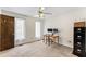 Bedroom with a ceiling fan, two windows and a desk near a closet and storage cabinet at 145 Traceway N, Sanford, NC 27332