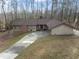 Charming single-story home featuring a long driveway and lush surroundings at 145 Traceway N, Sanford, NC 27332