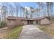 A single-story home with a brick facade, front yard, and attached carport at 145 Traceway N, Sanford, NC 27332