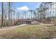 An exterior shot of a home with brick and siding with a large yard and circular driveway at 145 Traceway N, Sanford, NC 27332