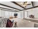 Bright living room featuring exposed wood beams and a dining space at 145 Traceway N, Sanford, NC 27332