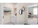 Functional laundry room with a washer, dryer, overhead storage and an artistic painting on the wall at 164 Ethel Ln, Angier, NC 27501