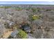 The aerial view of a house surrounded by a forest reveals the tree coverage and neighborhood layout at 2004 Beecham Cir, Raleigh, NC 27607