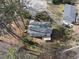 Aerial view of the backyard featuring a small patio and a house in the distance at 2004 Beecham Cir, Raleigh, NC 27607