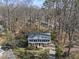 An aerial shot of the house surrounded by tall trees with the roof and front yard visible at 2004 Beecham Cir, Raleigh, NC 27607