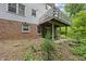 Back of home featuring a wooden deck, brick facade, and mature landscaping at 2004 Beecham Cir, Raleigh, NC 27607