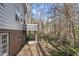 A house with a backyard featuring brick foundation, light-colored walls, and a small balcony at 2004 Beecham Cir, Raleigh, NC 27607