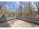 A railed balcony offers backyard and forest views at 2004 Beecham Cir, Raleigh, NC 27607