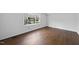 Bright bedroom with hardwood floors and a large window at 2004 Beecham Cir, Raleigh, NC 27607
