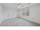 Bright bedroom featuring a ceiling fan, neutral carpeting, and two closets at 2004 Beecham Cir, Raleigh, NC 27607