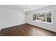 Bright dining room with hardwood flooring, a chandelier, and a large window at 2004 Beecham Cir, Raleigh, NC 27607