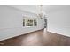 Bright dining room with hardwood flooring, a chandelier, and a large window at 2004 Beecham Cir, Raleigh, NC 27607