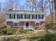 Charming two-story brick home featuring symmetrical design and manicured landscaping at 2004 Beecham Cir, Raleigh, NC 27607
