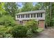 Charming two-story brick and siding home with a well-manicured front yard and mature landscaping at 2004 Beecham Cir, Raleigh, NC 27607
