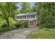 Charming two-story brick and siding home with a well-manicured front yard and mature landscaping at 2004 Beecham Cir, Raleigh, NC 27607