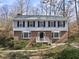 Well-manicured two-story home with a garden and stairs leading to the front door at 2004 Beecham Cir, Raleigh, NC 27607