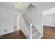 Bright foyer featuring a staircase with carpeted treads and light-colored wood flooring at 2004 Beecham Cir, Raleigh, NC 27607