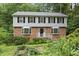 Charming two-story home with brick facade, complemented by black shutters and lush landscaping at 2004 Beecham Cir, Raleigh, NC 27607