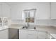 Well-lit kitchen featuring a stainless steel dishwasher and a double sink under a window at 2004 Beecham Cir, Raleigh, NC 27607