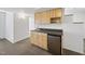 Well-lit kitchenette with wooden cabinets, a dark countertop, and compact appliances perfect for small living at 2004 Beecham Cir, Raleigh, NC 27607