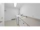 Functional laundry room with a modern washer and dryer, plus a large sink and practical countertop space at 2004 Beecham Cir, Raleigh, NC 27607