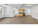 Bright living room with a kitchenette, natural light from a large window, and streamlined neutral carpet at 2004 Beecham Cir, Raleigh, NC 27607