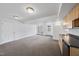 Open living room with kitchenette, bright lighting, and access to an outdoor patio through double doors at 2004 Beecham Cir, Raleigh, NC 27607