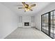 Bright living room featuring a fireplace, built-ins, sliding door, and carpet at 2004 Beecham Cir, Raleigh, NC 27607