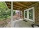 A covered patio space with double glass doors, perfect for outdoor gatherings at 2004 Beecham Cir, Raleigh, NC 27607