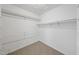 A simple walk-in closet with neutral carpet and multiple racks for storage, offering a practical organization solution at 2004 Beecham Cir, Raleigh, NC 27607