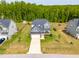 Aerial view of a lovely two-story home with a big yard surrounded by trees in a Gathering-friendly neighborhood at 201 Northview Dr, Middlesex, NC 27557