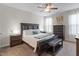 Spacious bedroom features a ceiling fan, large bed, and decorative touches at 201 Northview Dr, Middlesex, NC 27557