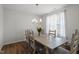 Bright dining room with wooden floors, a decorative chandelier, a large table, and sunlit windows at 201 Northview Dr, Middlesex, NC 27557