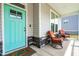 Inviting front porch featuring comfortable seating and a bright turquoise door at 201 Northview Dr, Middlesex, NC 27557