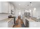 Bright modern kitchen with white cabinets, stainless steel appliances, granite countertops, and hardwood floors at 201 Northview Dr, Middlesex, NC 27557