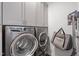 Laundry room with gray washer and dryer and ample cabinet storage at 201 Northview Dr, Middlesex, NC 27557