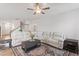 Spacious living room features a large white sofa, decorative rug, stylish furniture, and a staircase at 201 Northview Dr, Middlesex, NC 27557