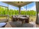 Covered porch furnished with an outdoor seating area for relaxation at 201 Northview Dr, Middlesex, NC 27557