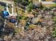 Aerial view of a home with a spacious yard and several outbuildings in a wooded setting at 217 Stephen Taylor Rd, Wake Forest, NC 27587