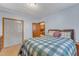Bedroom features a bed with blue plaid bedding and access to a closet and bathroom at 217 Stephen Taylor Rd, Wake Forest, NC 27587