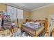 Bedroom with window and empty bed covered with items at 217 Stephen Taylor Rd, Wake Forest, NC 27587