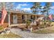 Inviting front porch area with stone pathway, brick and stone finishes, and lovely landscaping at 217 Stephen Taylor Rd, Wake Forest, NC 27587