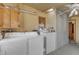 Bright laundry room featuring a washer, dryer, storage, and a ceiling fan at 217 Stephen Taylor Rd, Wake Forest, NC 27587