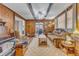 Cozy living room showcasing wood paneling, beamed ceiling, and ample natural light at 217 Stephen Taylor Rd, Wake Forest, NC 27587